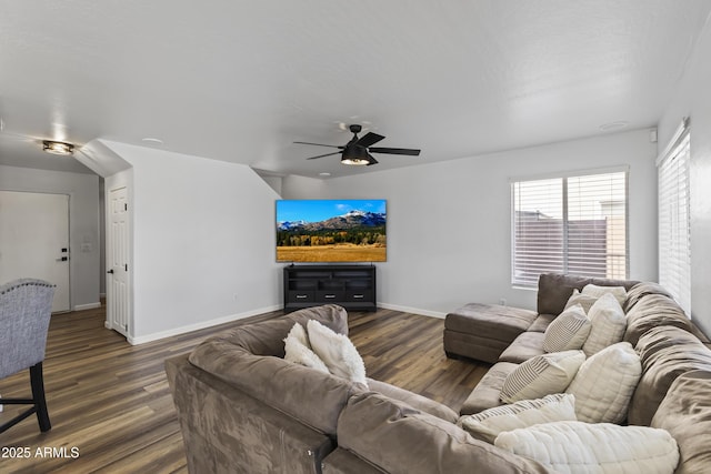 living room with dark wood-type flooring and ceiling fan