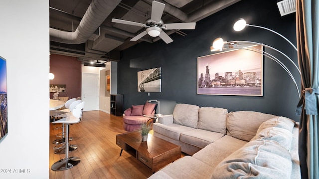 living room featuring ceiling fan and hardwood / wood-style floors