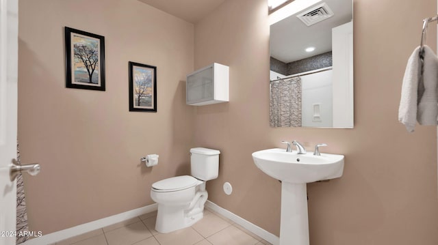 bathroom featuring tile patterned floors, sink, a shower with shower curtain, and toilet