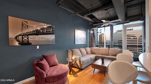 living room with ceiling fan and light hardwood / wood-style floors