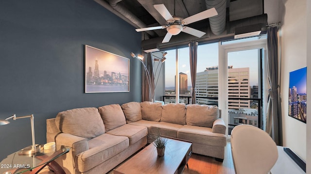 living room with hardwood / wood-style flooring and ceiling fan