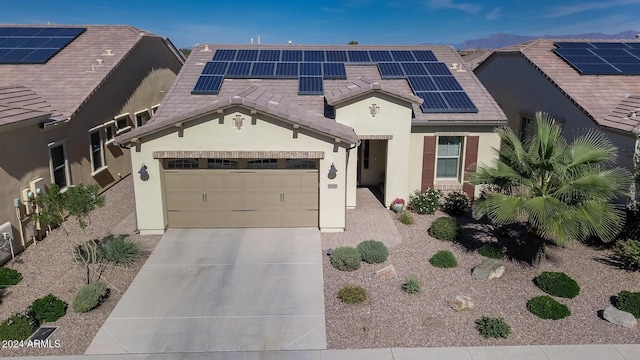 view of front of property with a garage and solar panels