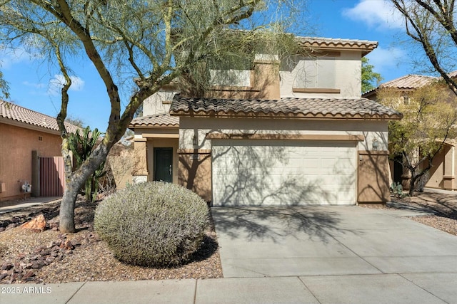 mediterranean / spanish house featuring stucco siding, an attached garage, a tile roof, and concrete driveway