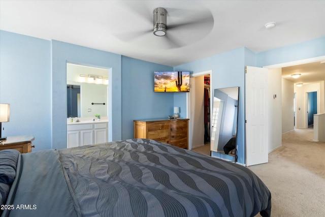 bedroom featuring ceiling fan, connected bathroom, and carpet