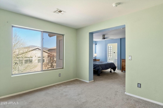 unfurnished bedroom featuring visible vents, baseboards, and carpet