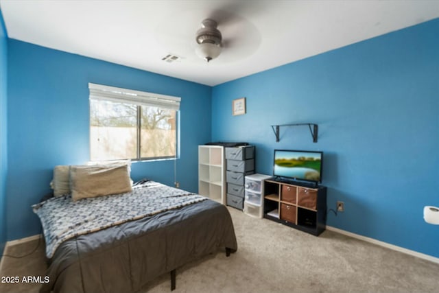 carpeted bedroom with visible vents, baseboards, and a ceiling fan