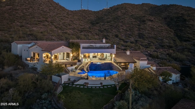 rear view of house featuring a patio area and a mountain view