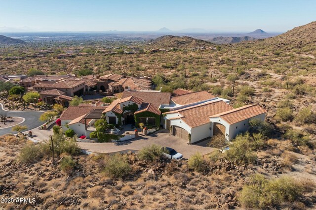 birds eye view of property with a mountain view