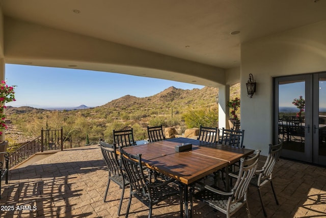 view of patio with a mountain view and french doors