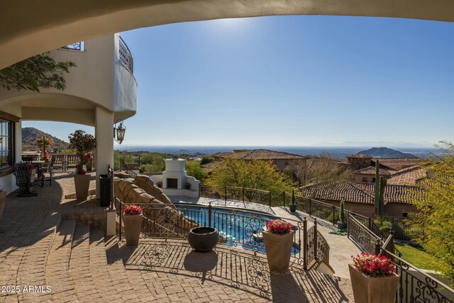 view of pool with a mountain view and a patio