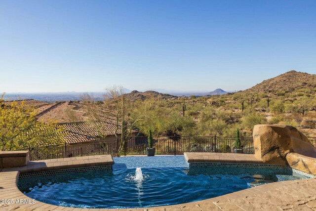 view of swimming pool featuring a mountain view