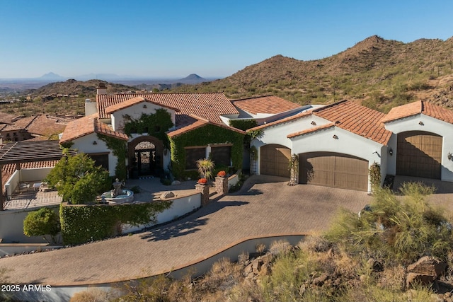 mediterranean / spanish home with a mountain view and a garage