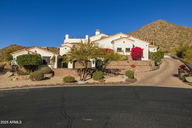 mediterranean / spanish home with a mountain view