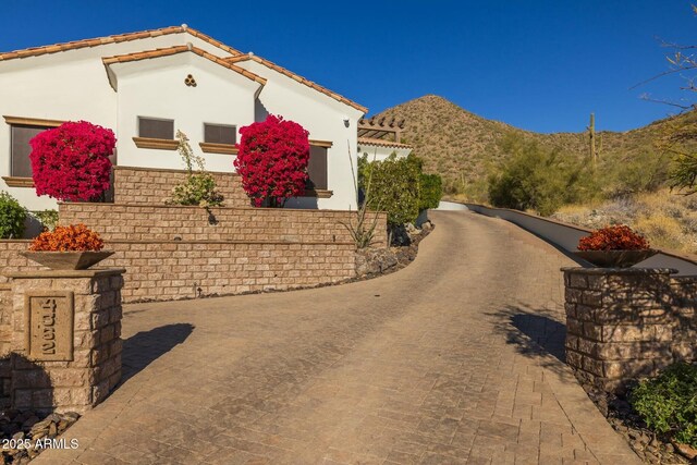 view of side of home with a mountain view