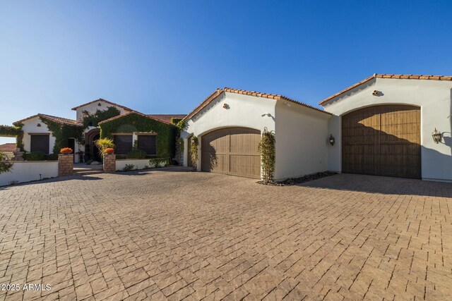 mediterranean / spanish home with a garage