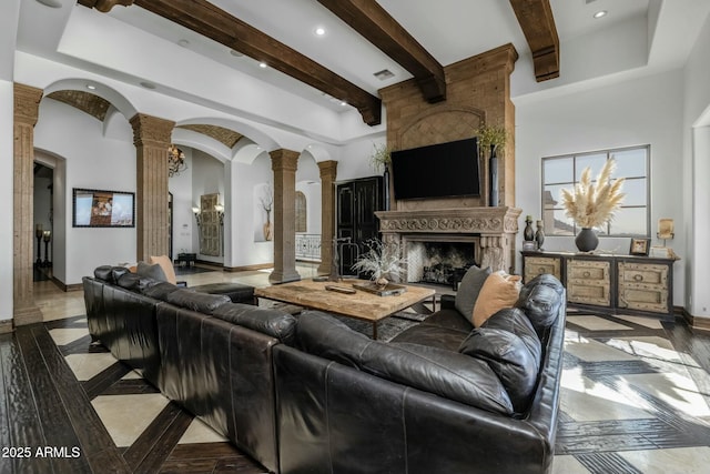 living room with ornate columns and a premium fireplace