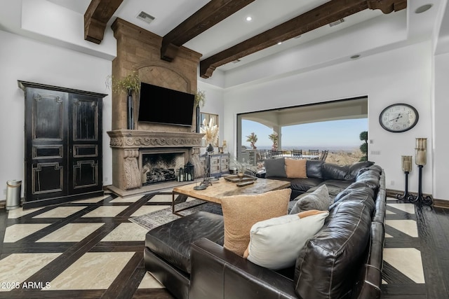 living room with beamed ceiling and a high end fireplace