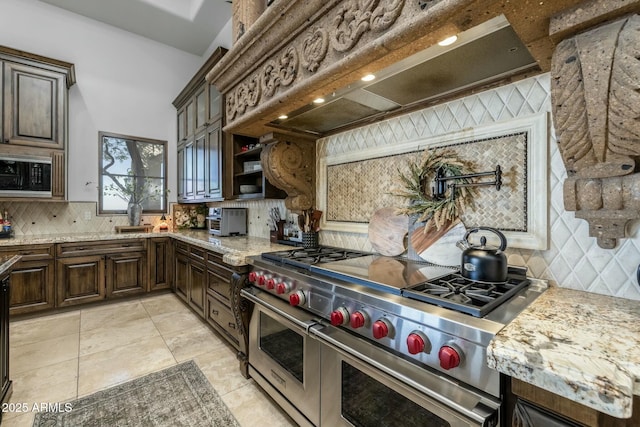 kitchen with dark brown cabinetry, tasteful backsplash, double oven range, and custom exhaust hood