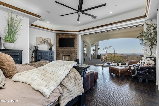 living room featuring a raised ceiling, ceiling fan, dark hardwood / wood-style flooring, and crown molding