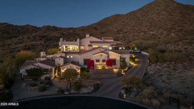 birds eye view of property with a mountain view