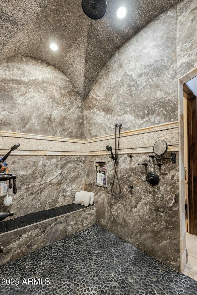 bathroom featuring vaulted ceiling and walk in shower