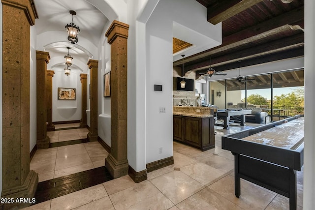 hall featuring ornate columns, beamed ceiling, wooden ceiling, and light tile patterned floors