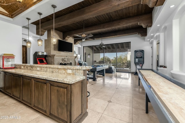 kitchen featuring wooden ceiling, ceiling fan, decorative light fixtures, beam ceiling, and dark brown cabinets