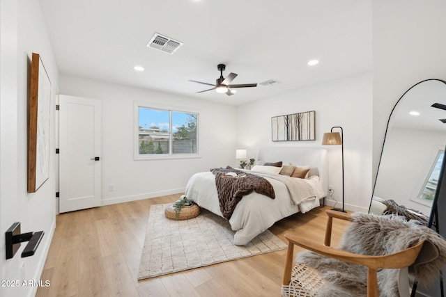 bedroom with ceiling fan and light hardwood / wood-style floors