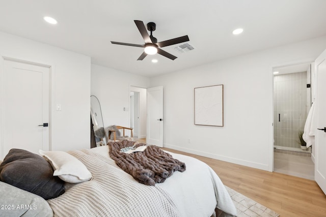 bedroom featuring ensuite bath, light hardwood / wood-style floors, and ceiling fan