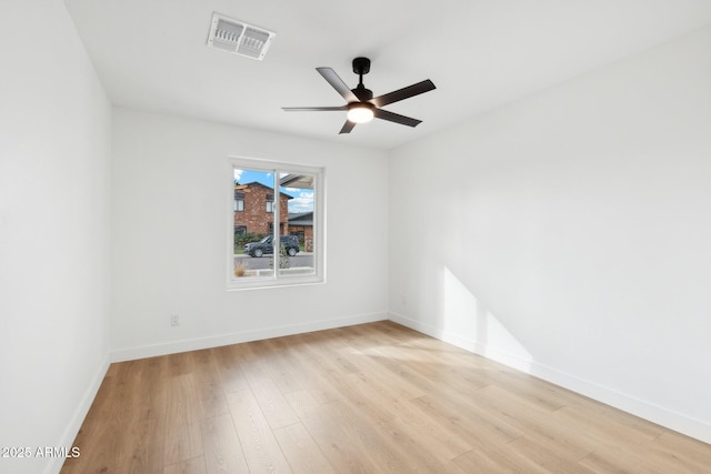 spare room featuring light hardwood / wood-style floors and ceiling fan