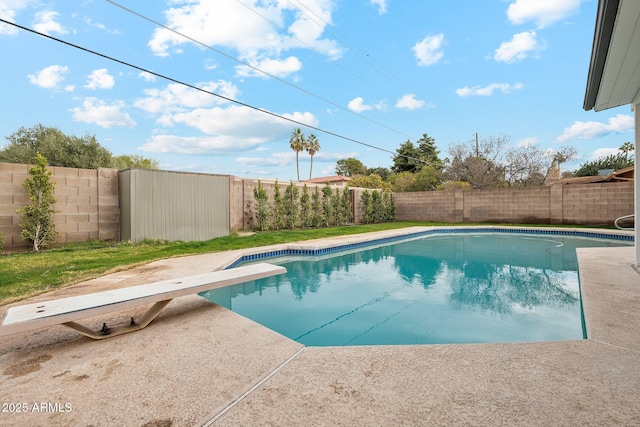 view of pool with a diving board