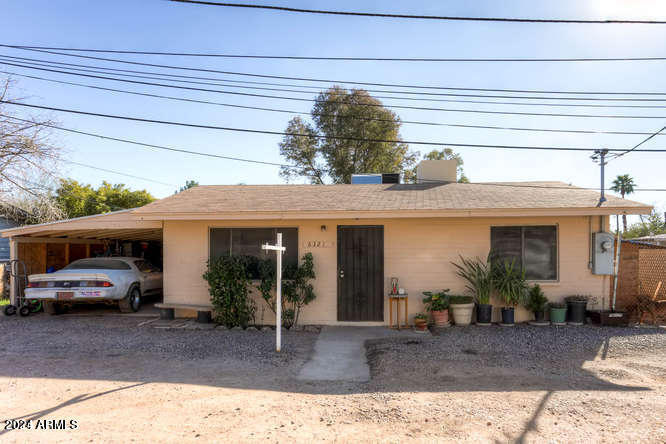 6321 N 65th Dr, Glendale, AZ 85301 - view of front of property with an attached carport, driveway, and stucco siding