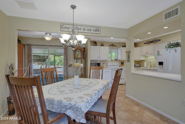 dining space featuring ceiling fan with notable chandelier, sink, and light tile patterned floors