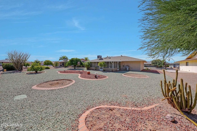 view of yard with a sunroom and a patio