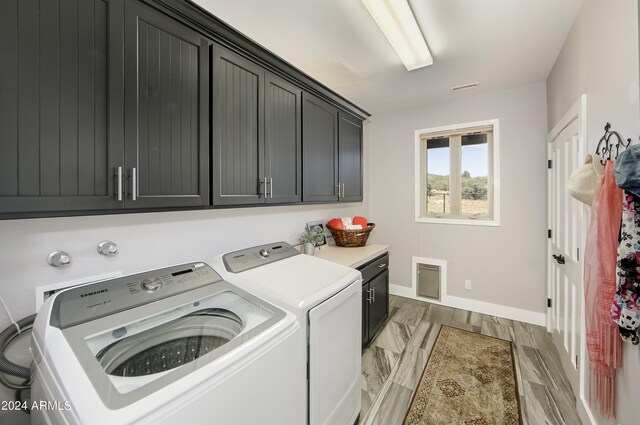 laundry area featuring cabinets and independent washer and dryer