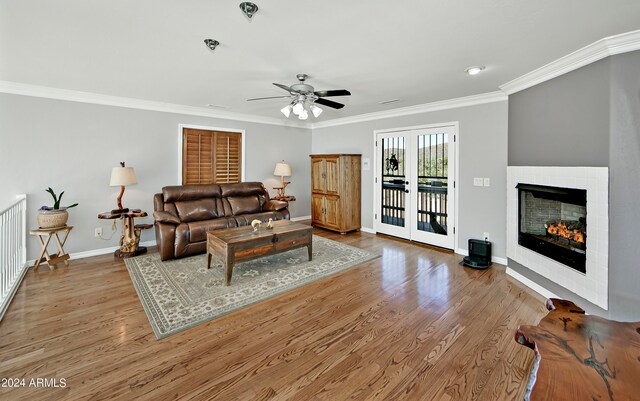 living room with ceiling fan, crown molding, wood-type flooring, and french doors