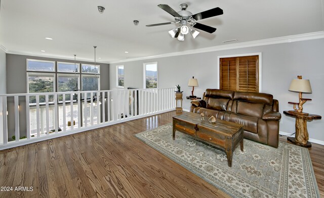 living room featuring ceiling fan, dark wood-type flooring, and ornamental molding