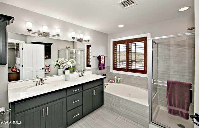 bathroom with tile patterned floors, double sink vanity, and shower with separate bathtub