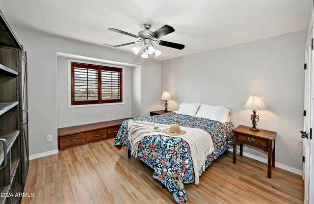 bedroom with ceiling fan and light hardwood / wood-style floors