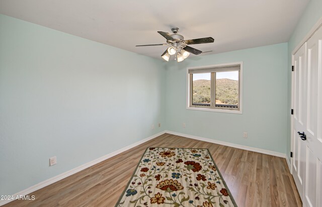 bedroom with a closet, ceiling fan, and light wood-type flooring