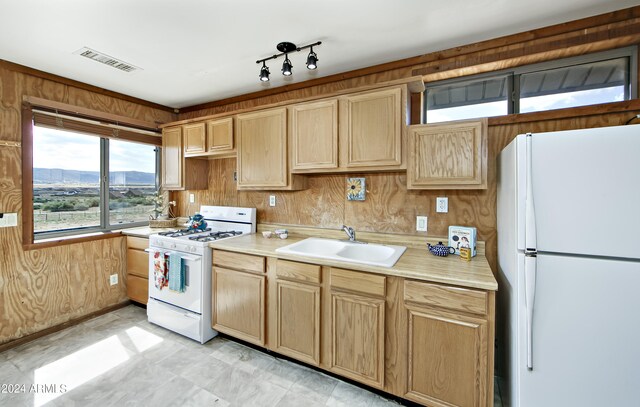 kitchen featuring light tile patterned floors, a mountain view, sink, and white appliances