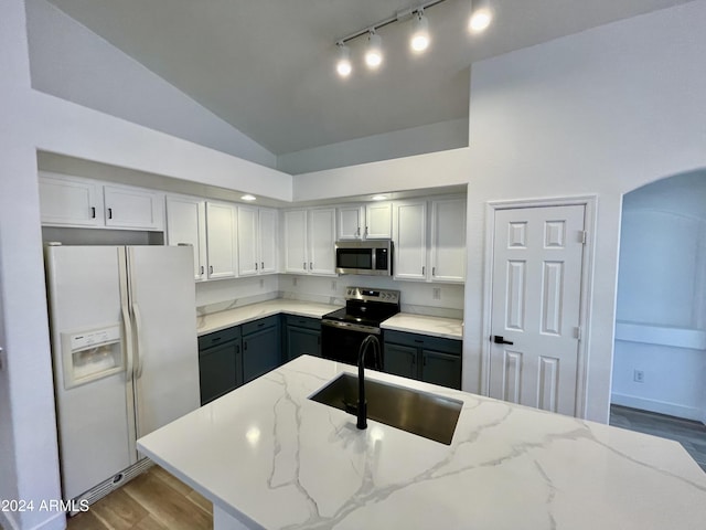 kitchen with appliances with stainless steel finishes, light stone counters, sink, high vaulted ceiling, and gray cabinets