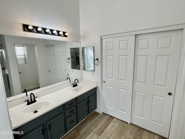 bathroom with hardwood / wood-style flooring, vanity, and toilet