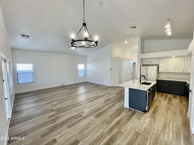 kitchen with light hardwood / wood-style flooring, white cabinetry, and a healthy amount of sunlight