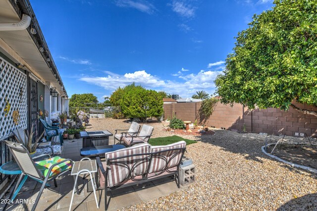 view of yard featuring a patio area, a fenced backyard, and an outdoor hangout area