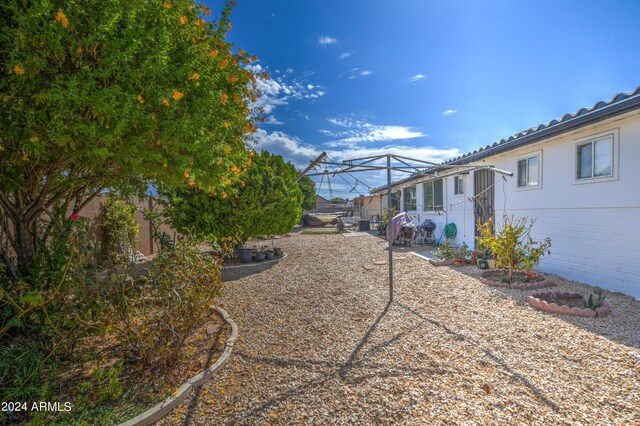 view of yard with a patio area, a lanai, and fence