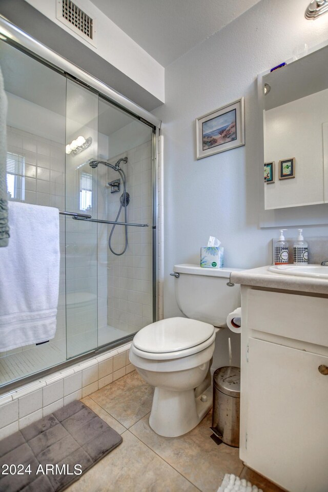 full bathroom featuring a stall shower, visible vents, vanity, and toilet