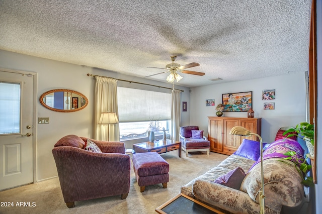 carpeted living room with ceiling fan and a textured ceiling