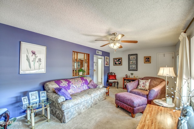 carpeted living room featuring a textured ceiling and ceiling fan