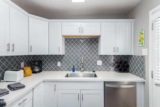 kitchen with dishwasher, decorative backsplash, white cabinets, and sink